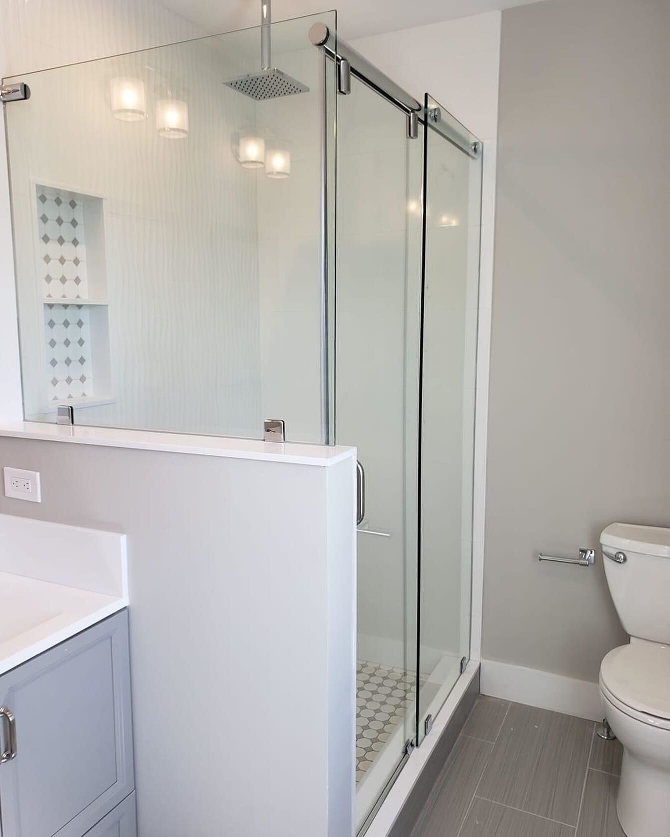 A bathroom with a toilet a sink and a shower