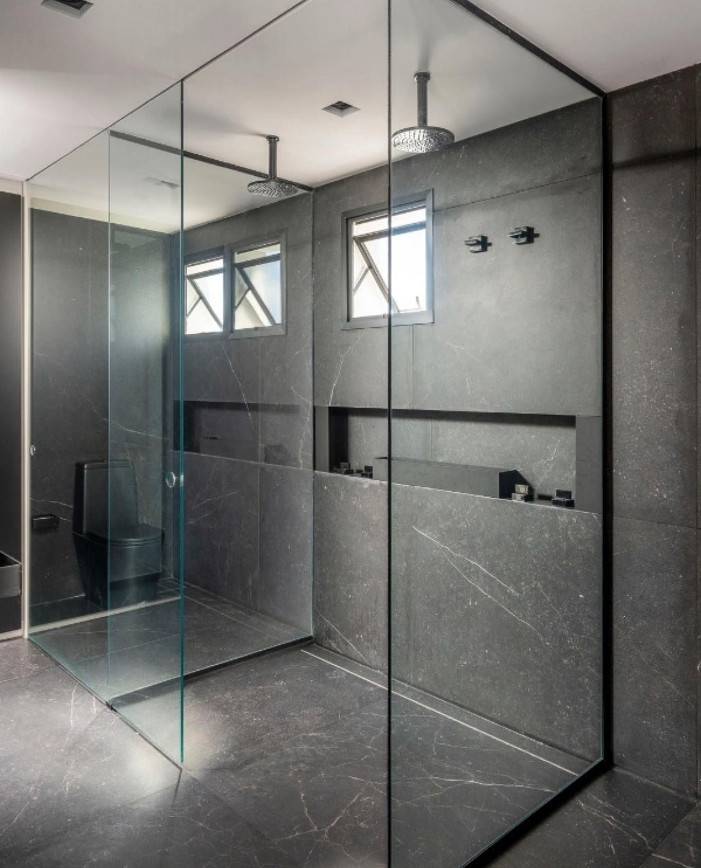 A bathroom with a walk in shower and a toilet