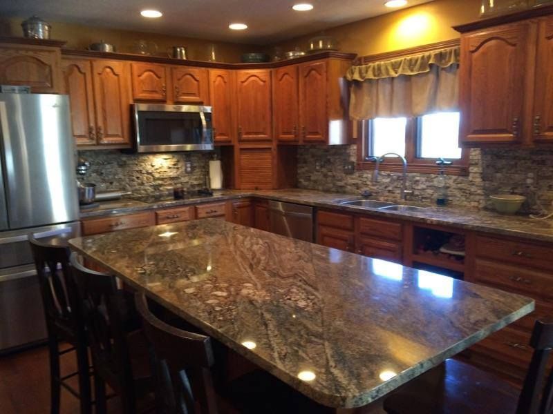A kitchen with granite counter tops and stainless steel appliances