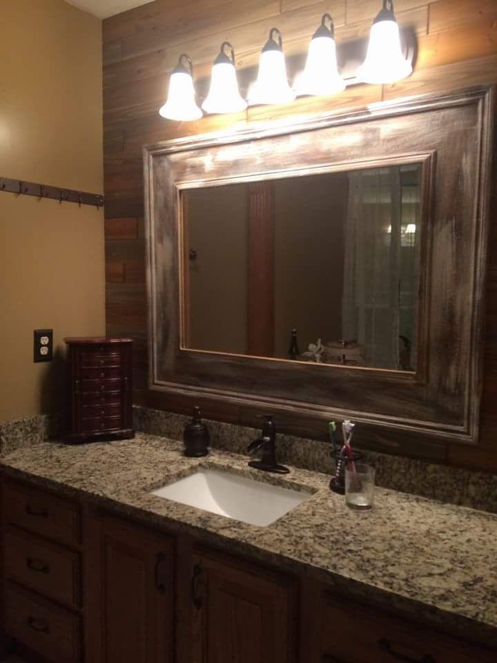 A bathroom with a sink and a large mirror
