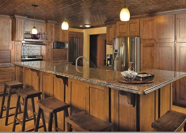 A kitchen with wooden cabinets and granite counter tops