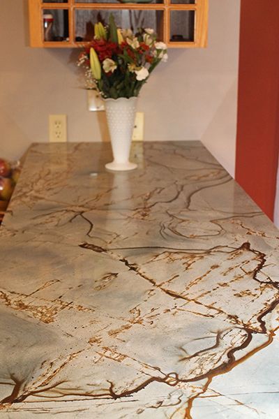 A marble counter top with a vase of flowers on it