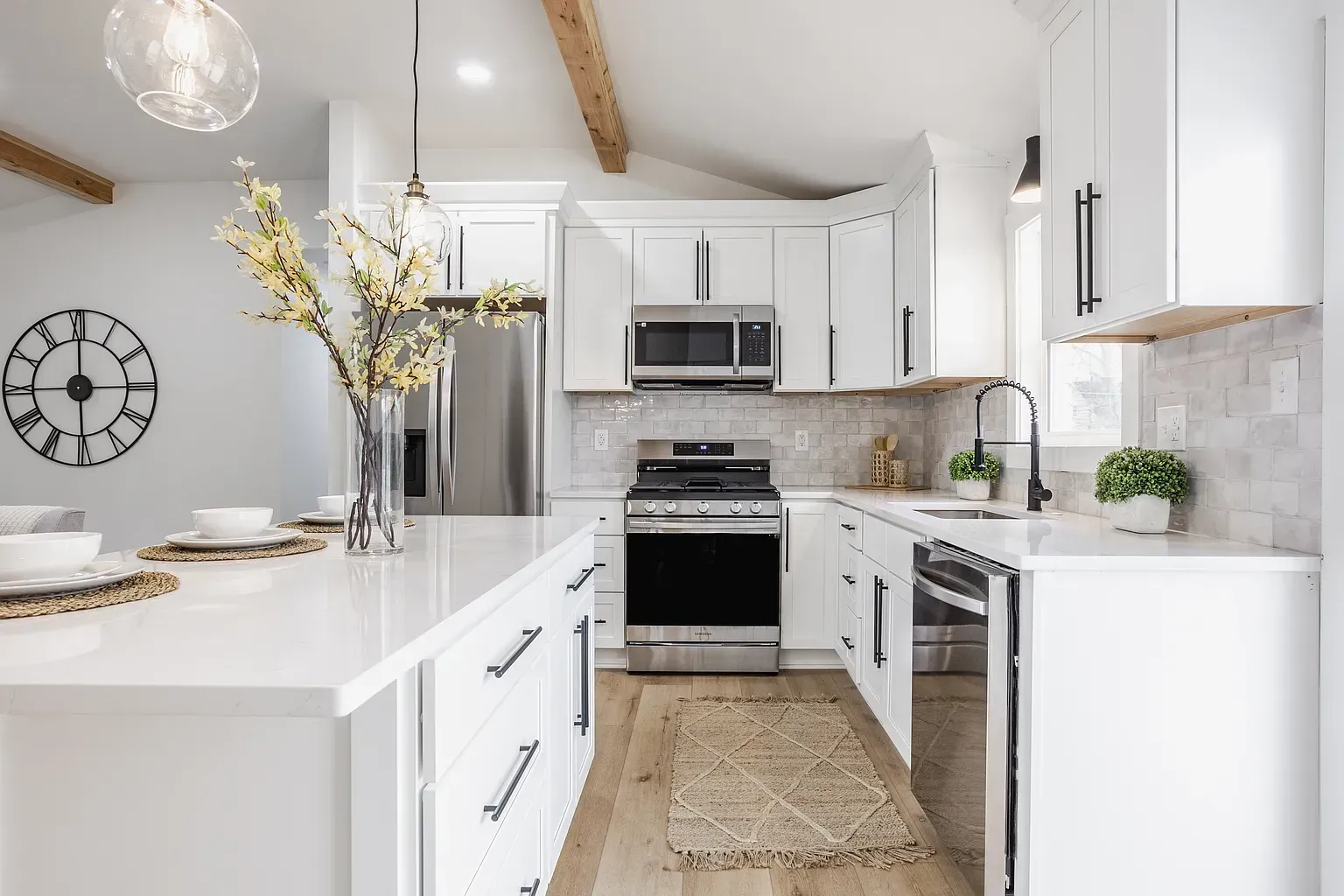 A kitchen with granite counter tops and stainless steel appliances.