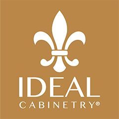 A logo for ideal cabinetry with a fleur de lis on a brown background.
