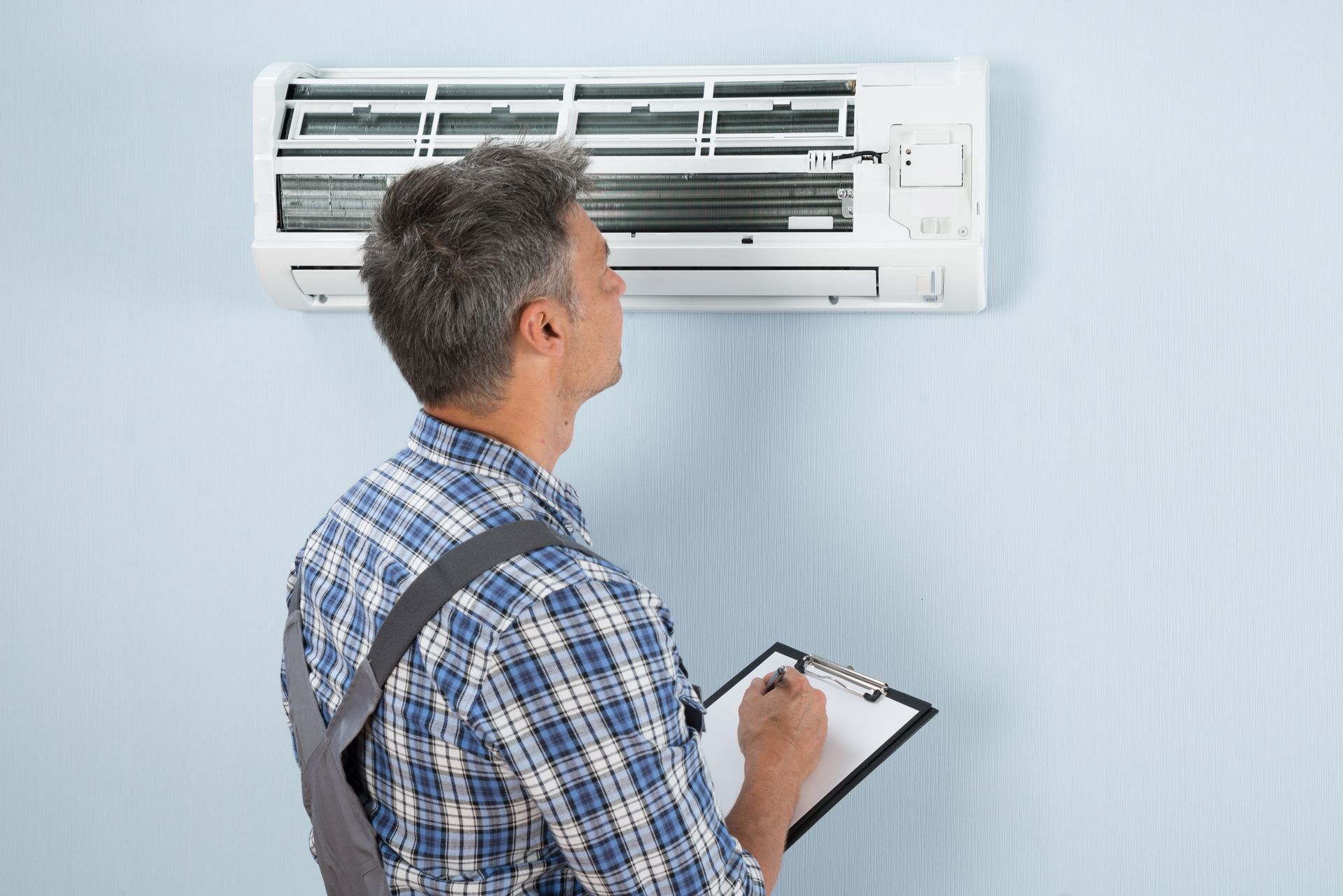 Man Is Looking At The Air Conditioner - Lexington, NC - Bailey Oil Co. Inc.