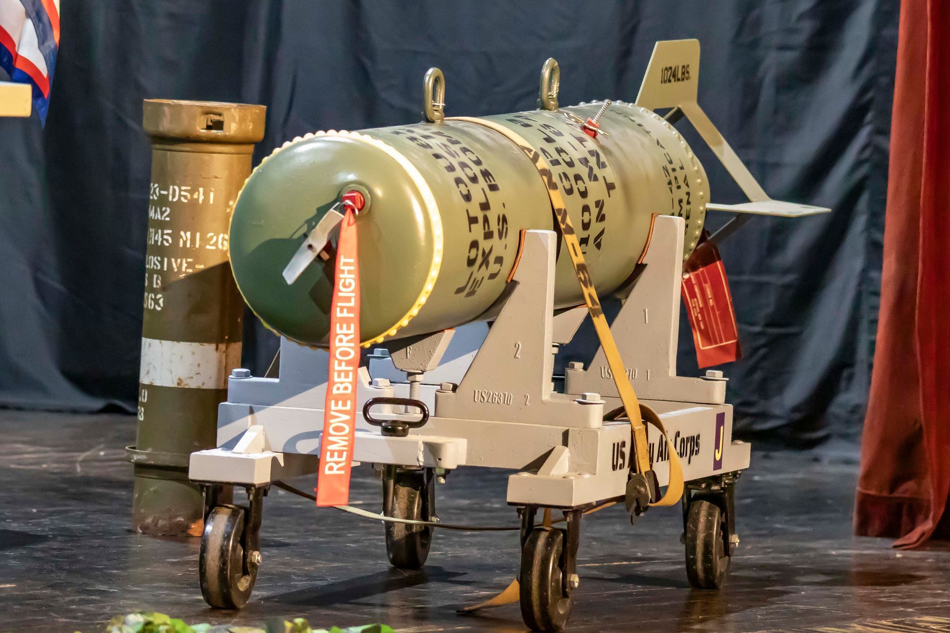 Green bomb on a transport cart; 
