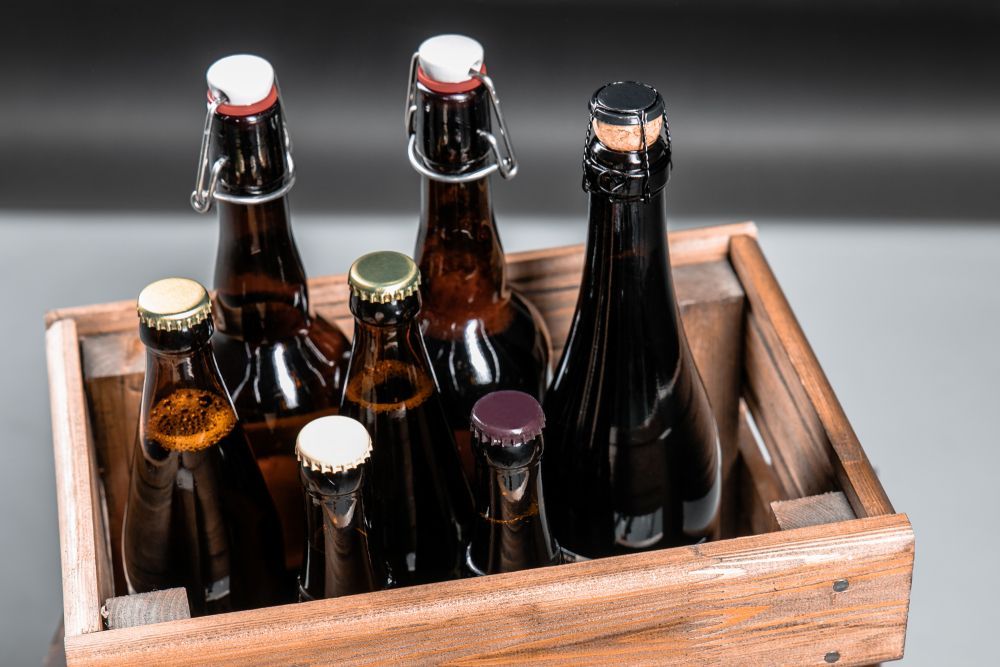 Wooden Crate Filled With Several Brown Beer Bottles — BYO Cellars in Medowie, NSW