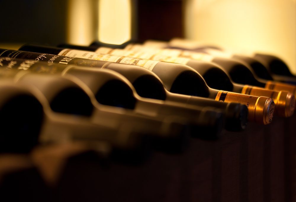 Bottles of Wine on a Rack  Necks Lined Up, Labels Visible, Soft Lighting — BYO Cellars in Forster, NSW