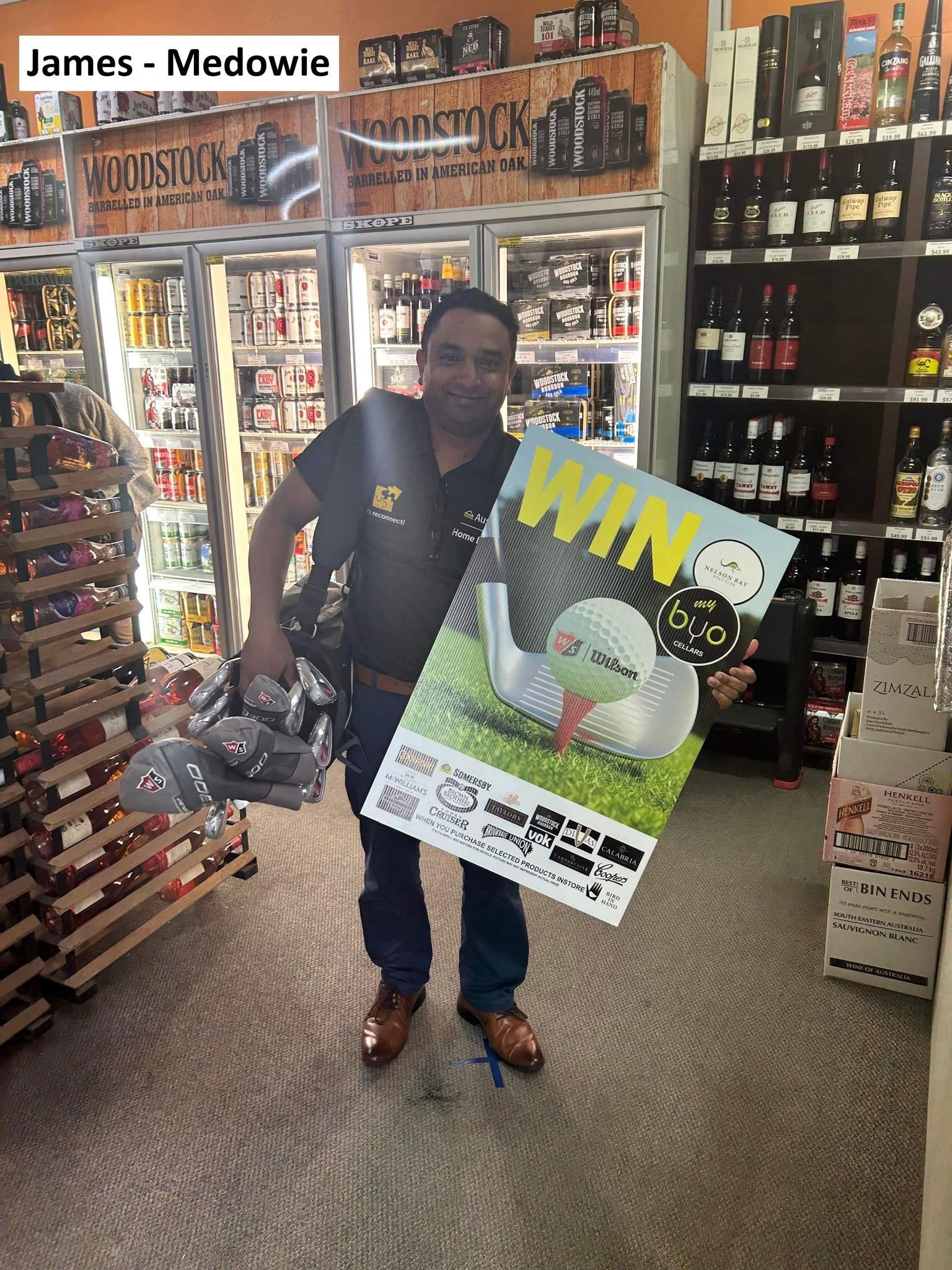 Man in a liquor store holds a golf club set and