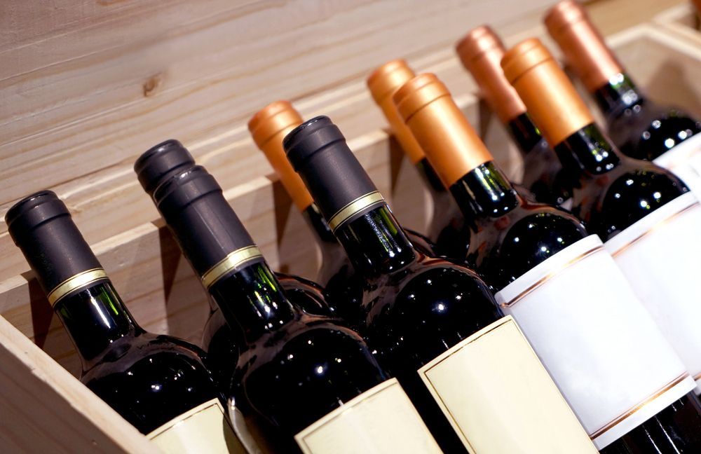 Bottles of Red Wine in a Wooden Crate, Angled — BYO Cellars in Hawks Nest, NSW