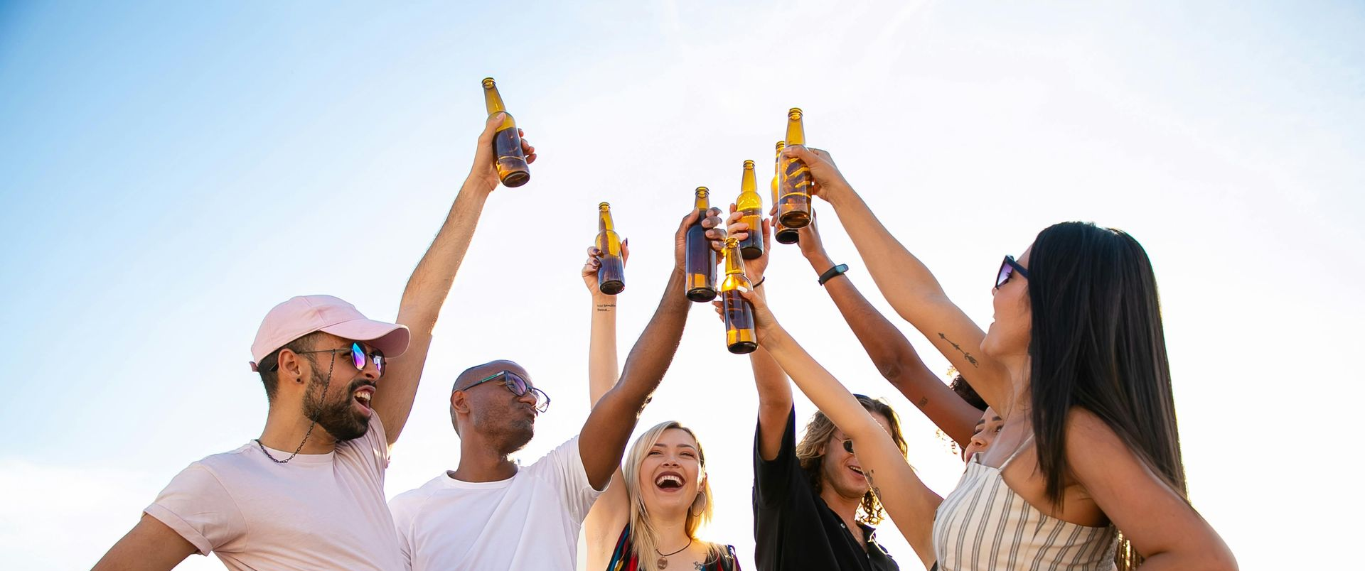 People Celebrating, Holding Up Craft Beer Bottles — BYO Cellars in Tuncurry, NSW