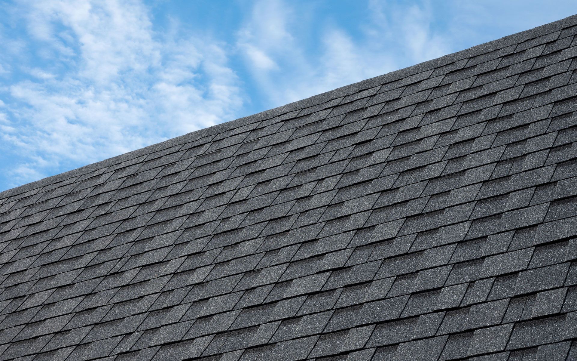 A close up of a roof with a blue sky in the background.