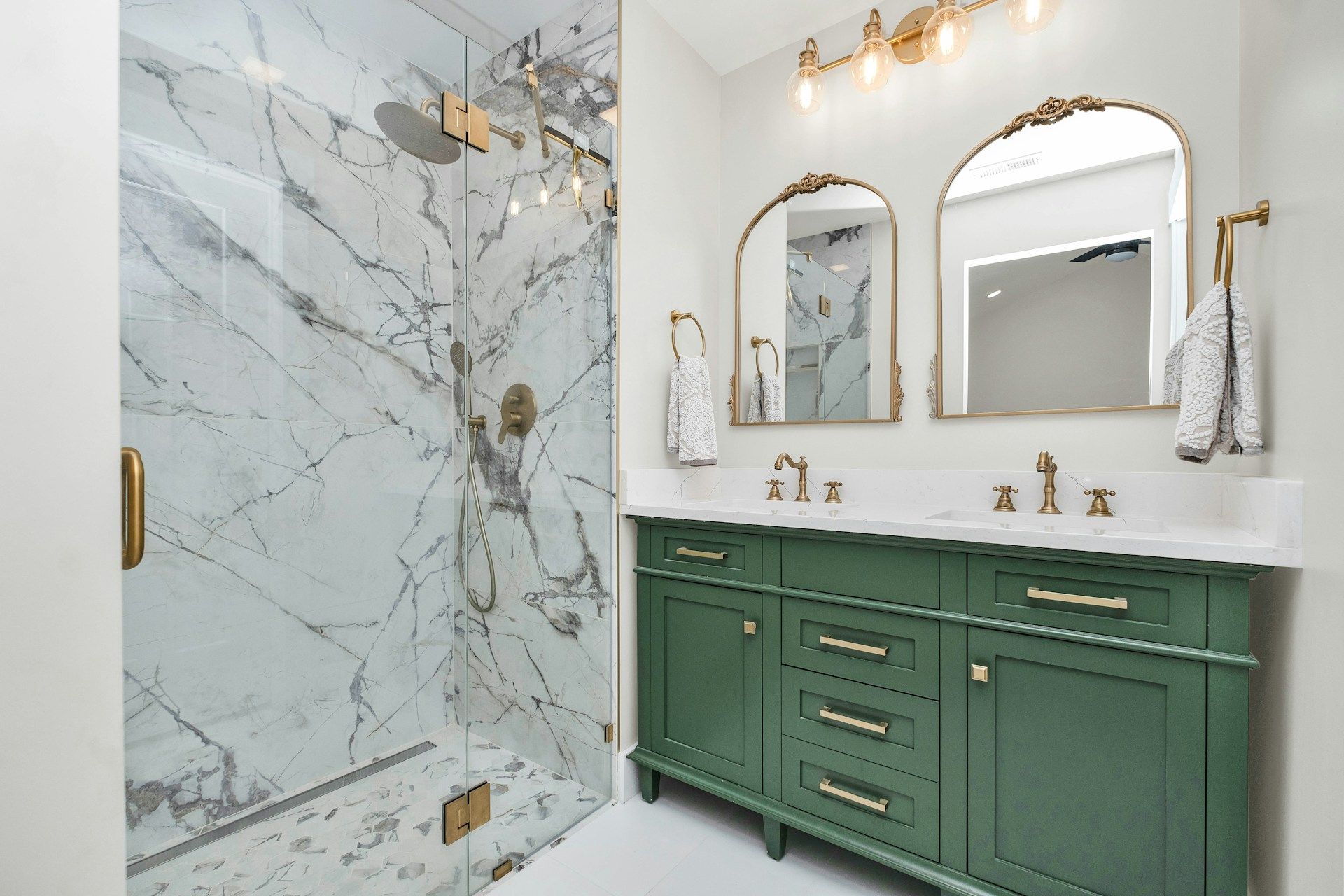 Classic bathroom remodeled with marble and gold accents