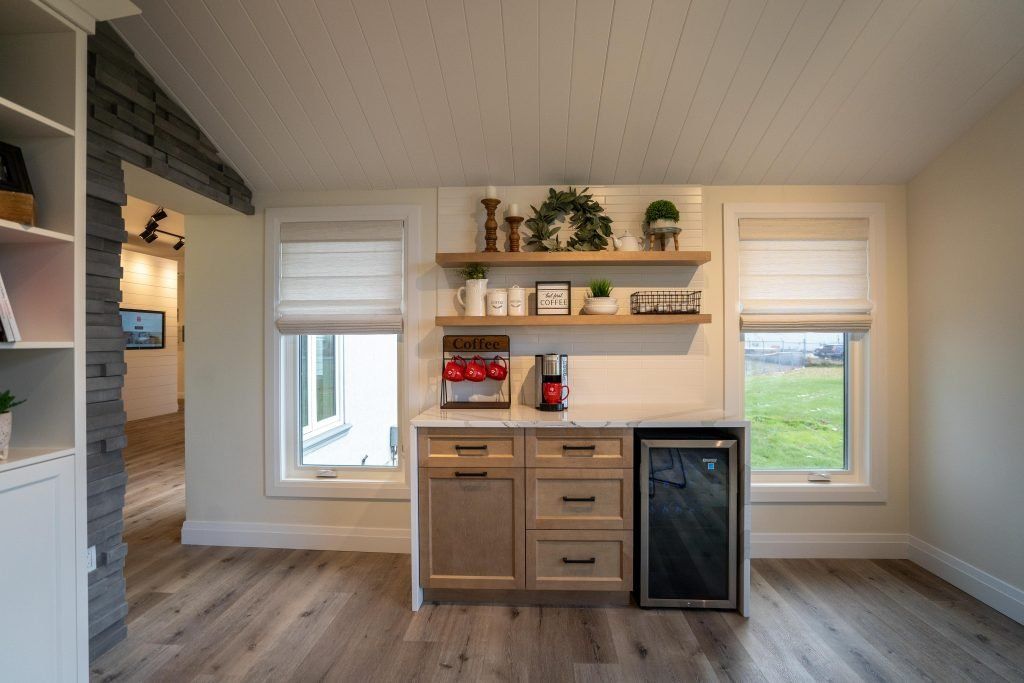 There is a refrigerator in the middle of the room.