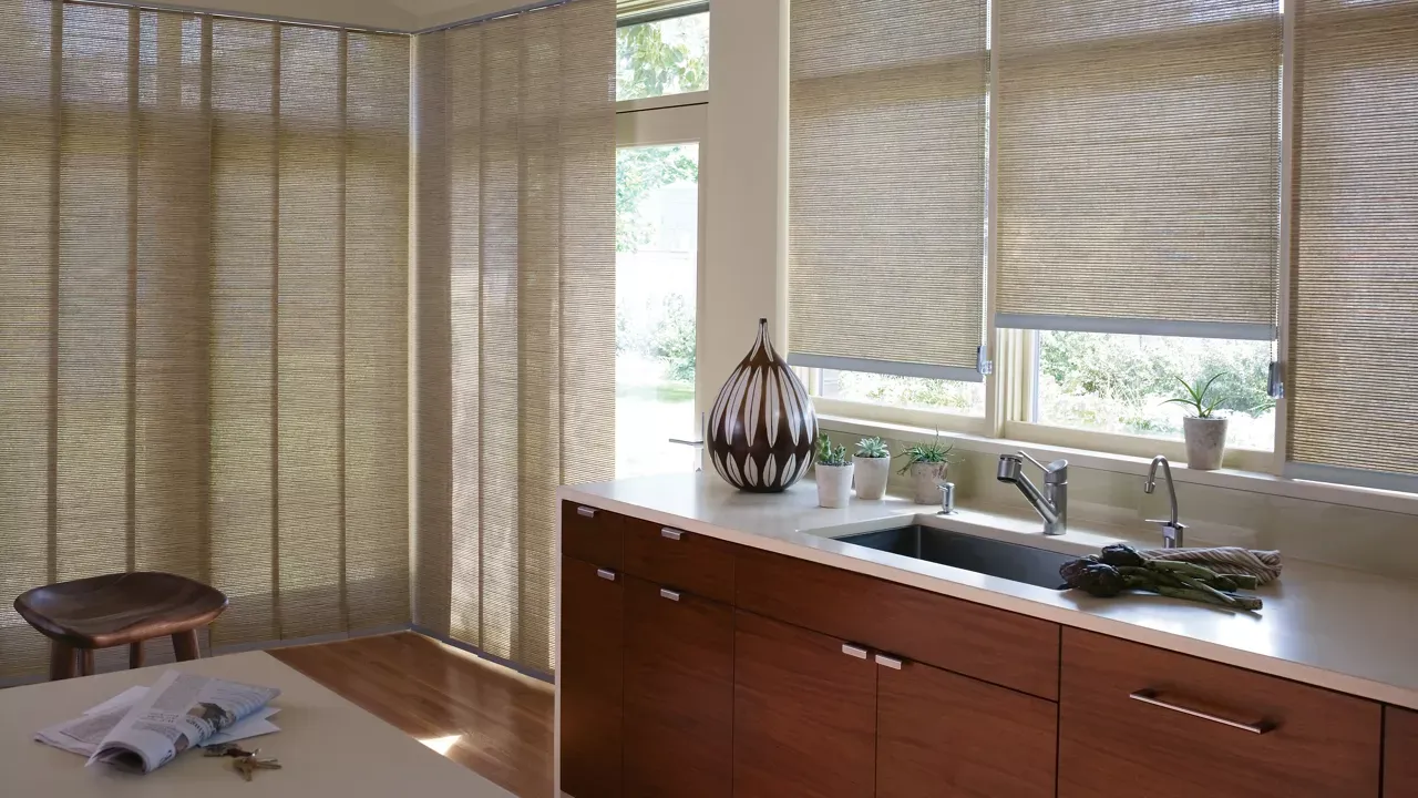 A kitchen with a sink and a window with blinds