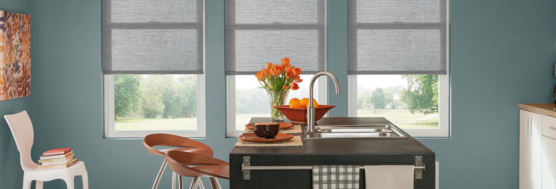 A kitchen with a sink , chairs , and a large island.