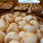 Cesta de pan con queso y más pan en el fondo; un icono de nube de lluvia superpuesto.