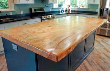 A kitchen with a large wooden counter top.