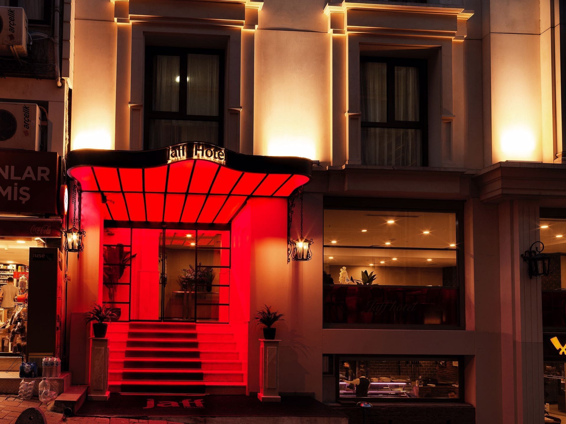A hotel with a red awning and stairs
