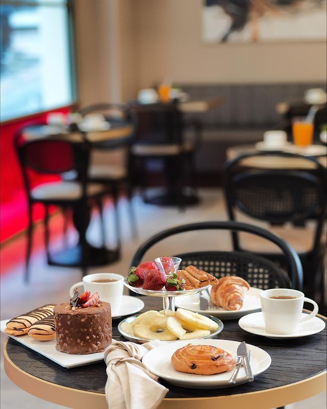 A table with plates of food on it in a restaurant