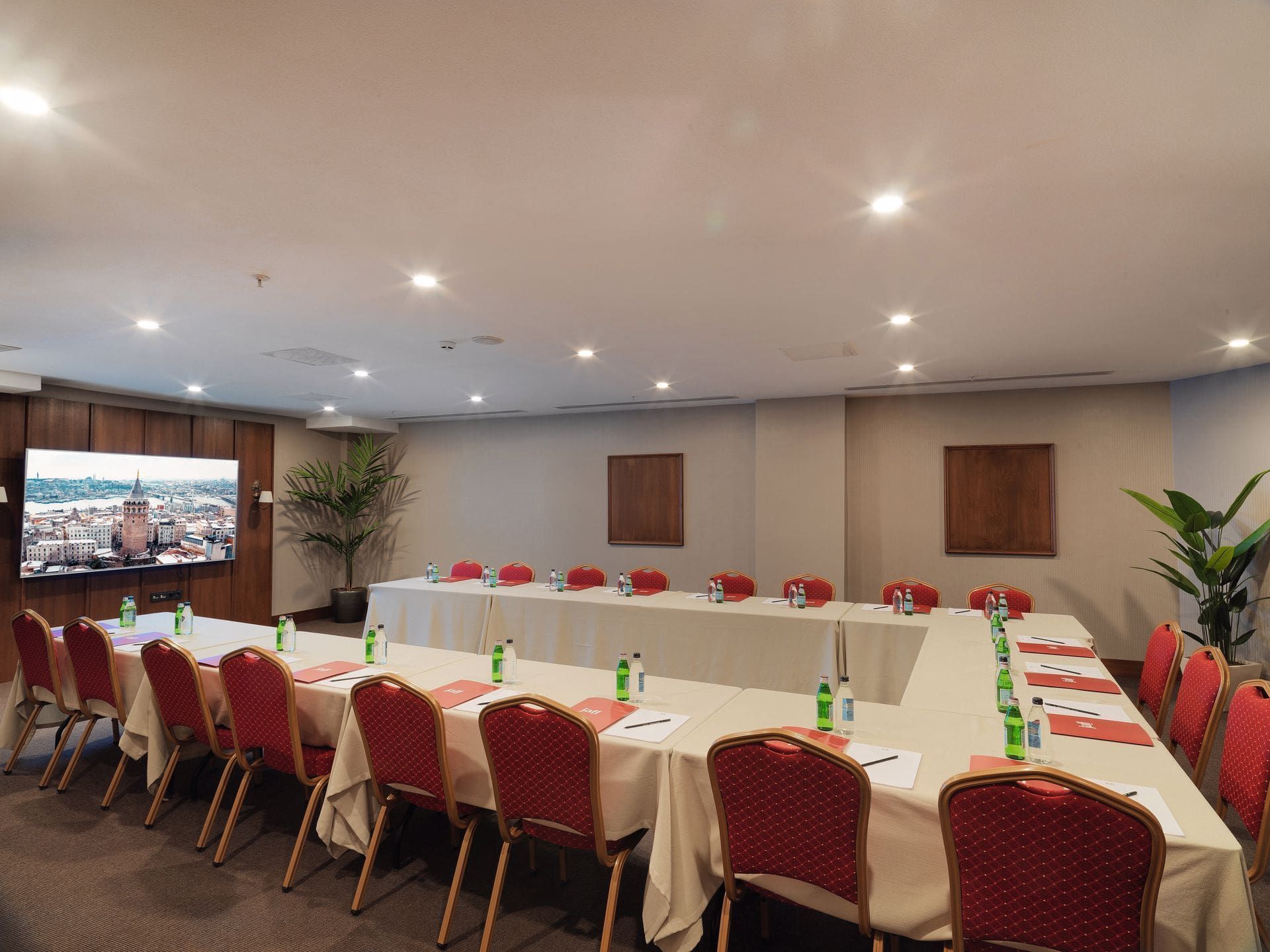 A conference room with tables and chairs set up for a meeting