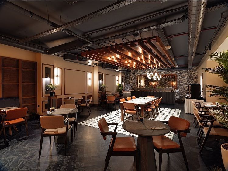 An artist 's impression of a restaurant with tables and chairs.