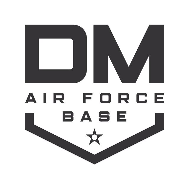 Logo for Davis-Monthan Air Force Base: "DM" in bold text above "AIR FORCE BASE" inside a shield with a star.