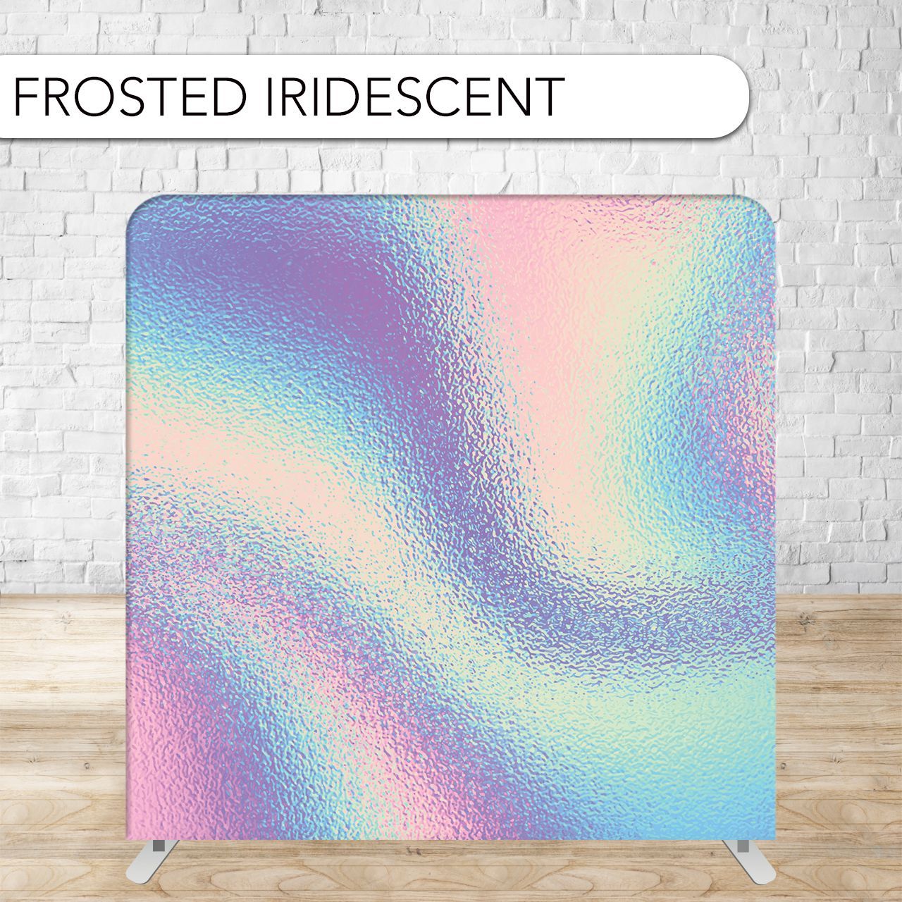 Frosted iridescent backdrop with pastel colors, against a light brick wall and wooden floor.