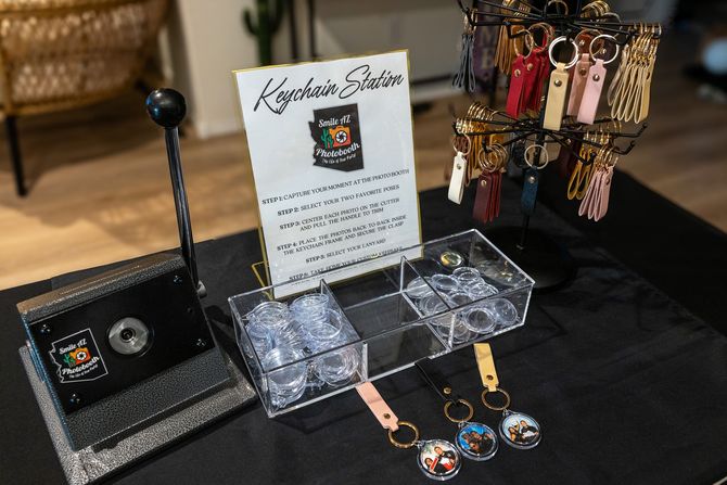 Keychain station display with press, sign, keychains, and clear containers.