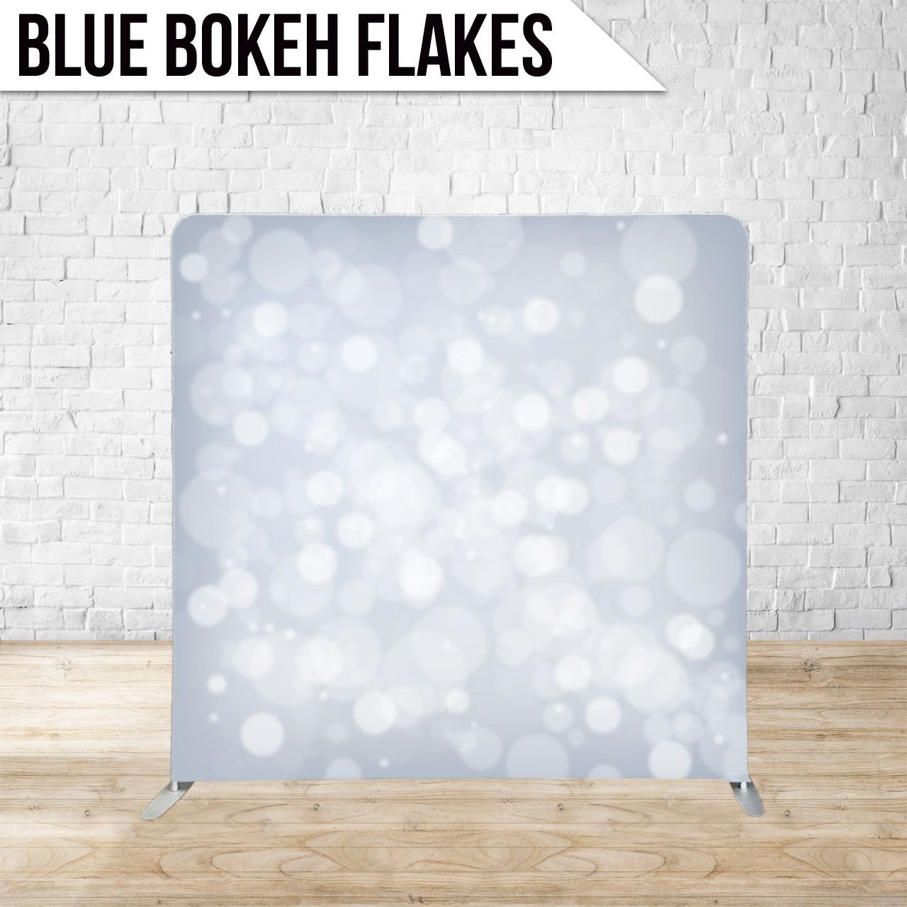 Blue bokeh flakes backdrop with a white brick wall background.