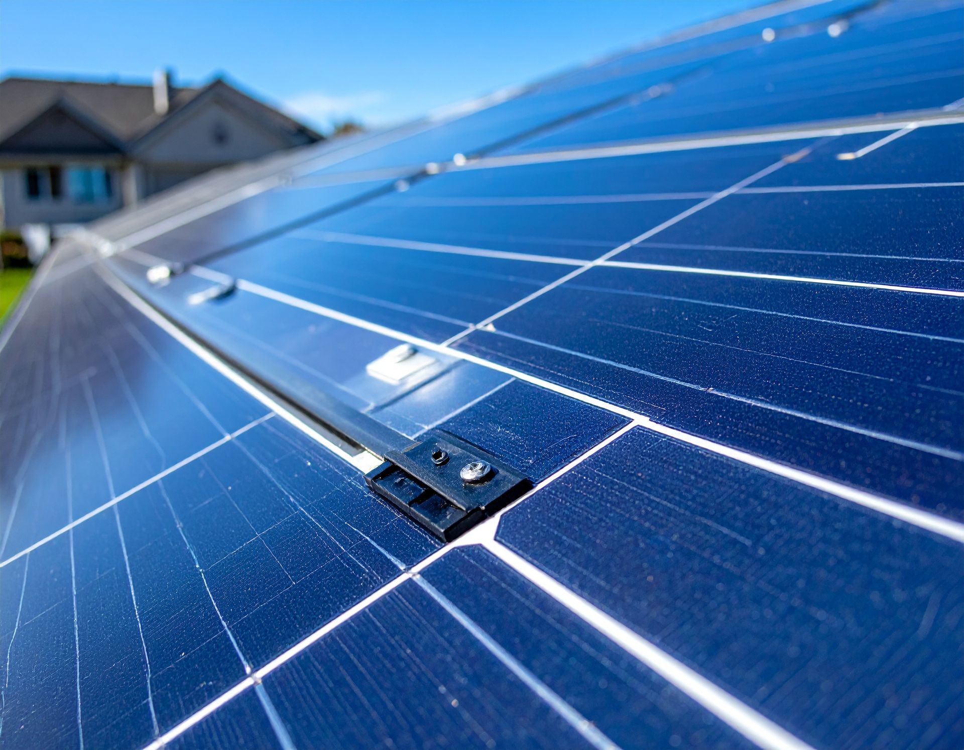 Solar panels on a residential roof, angled toward the sky on a sunny day.