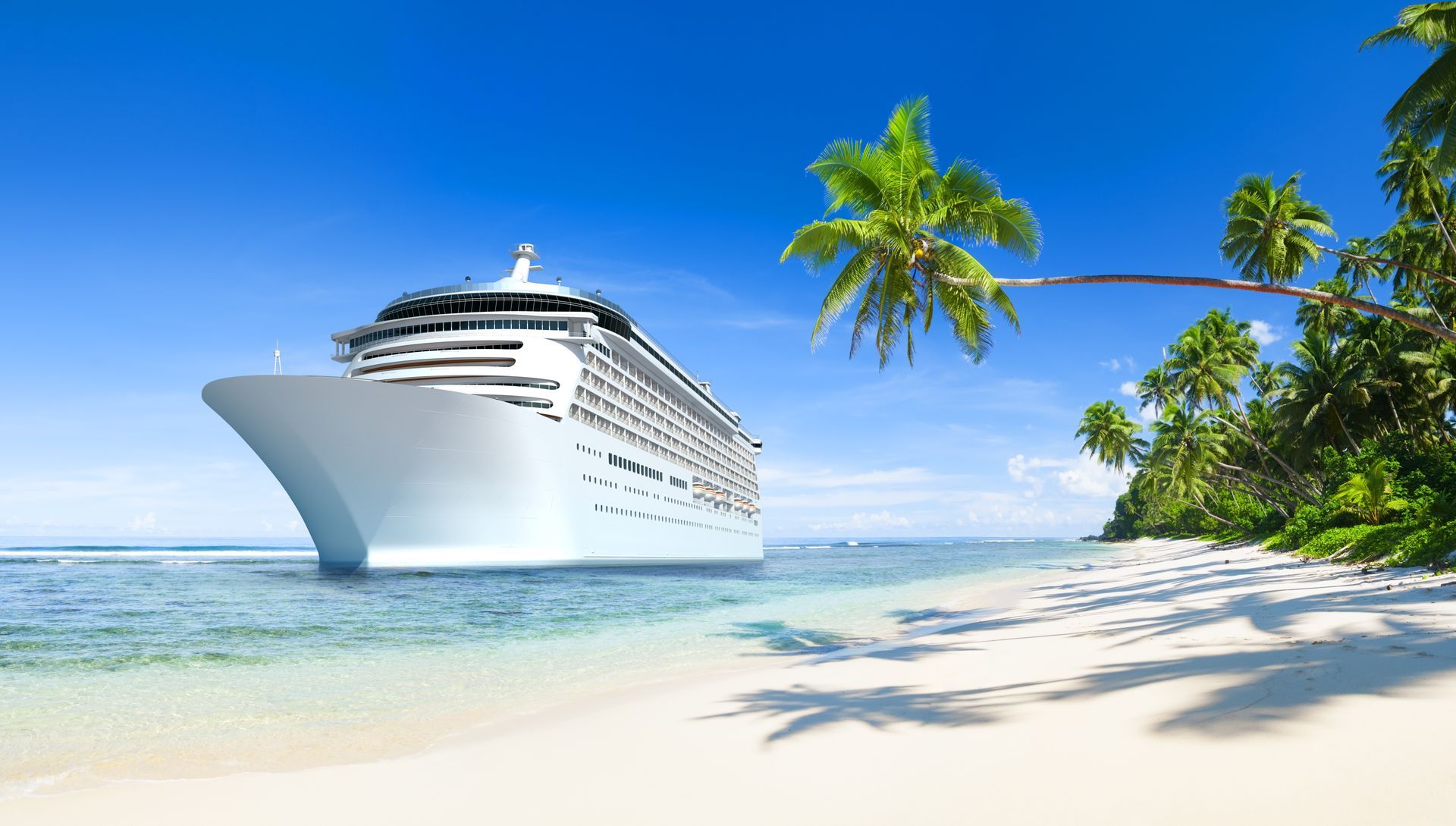Cruise ship near a tropical beach with clear water and palm trees.