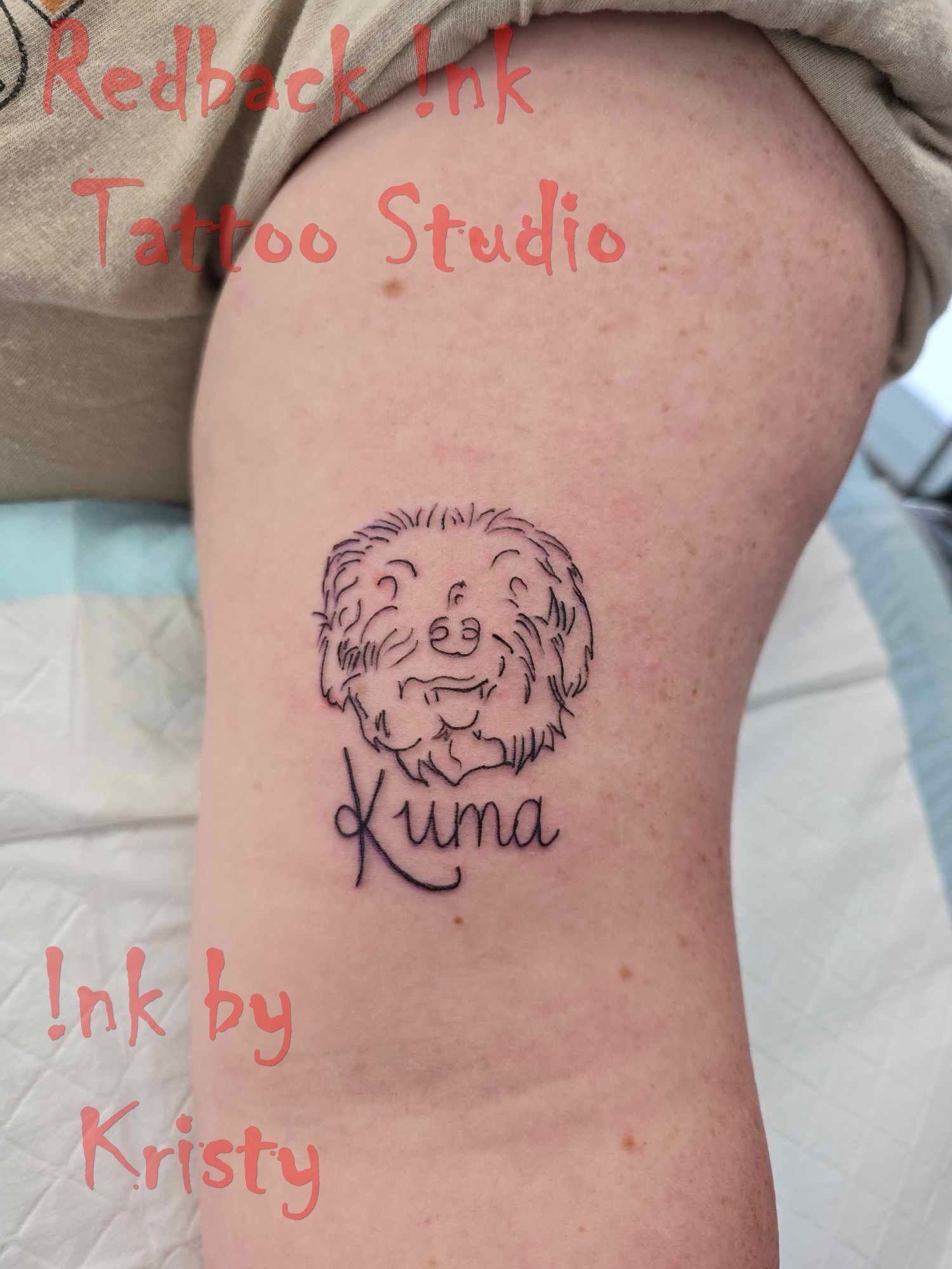 Line Art Tattoo of a Dog's Face With the Name 
