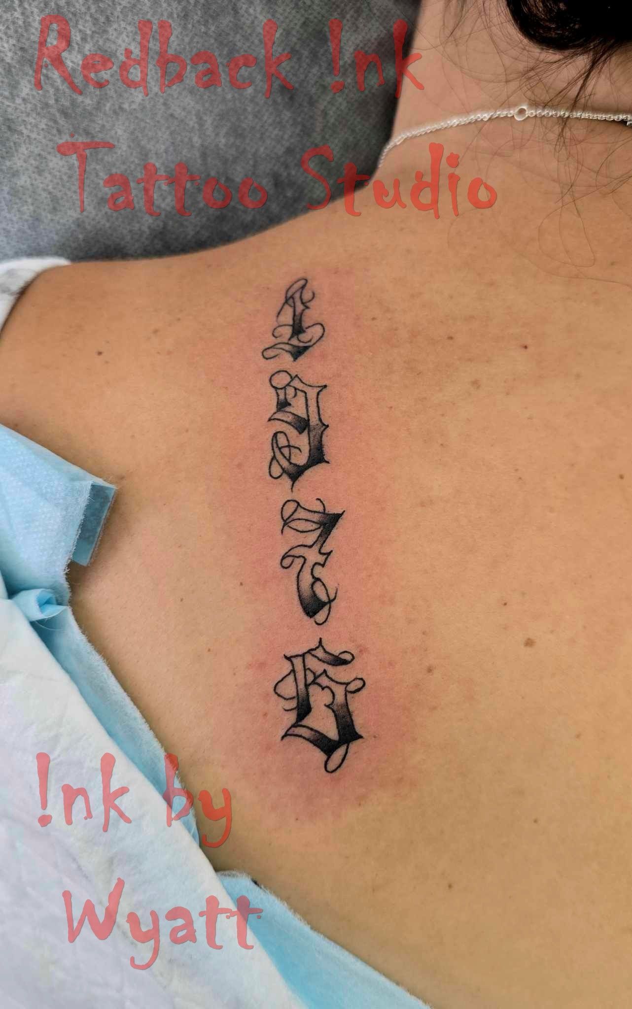 Tattoo of Five Spine Vertebrae in Black Ink on a Person's Back — Redback !nk Tattoo Studio in Kawana, QLD