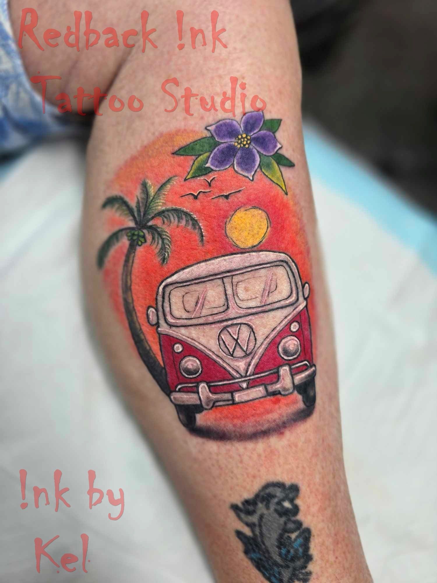 Tattoo of a red and white van with a palm tree, sunset, and purple flower on a leg.