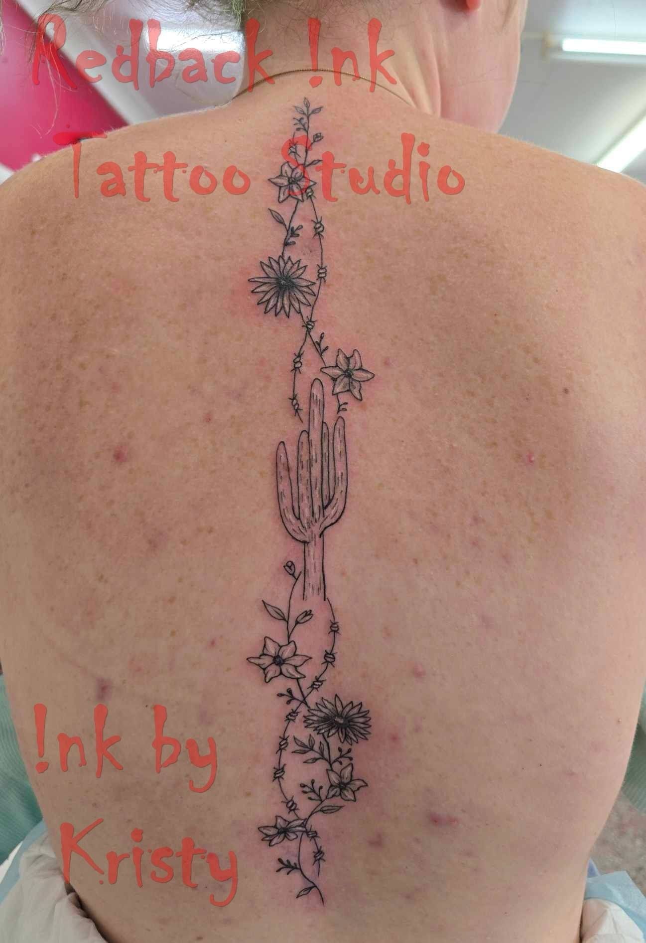 Tattoo of a cactus and flowers down the back of a person. Ink by Kristy, Redback Ink Tattoo Studio — Redback !nk Tattoo Studio in Kawana, QLD