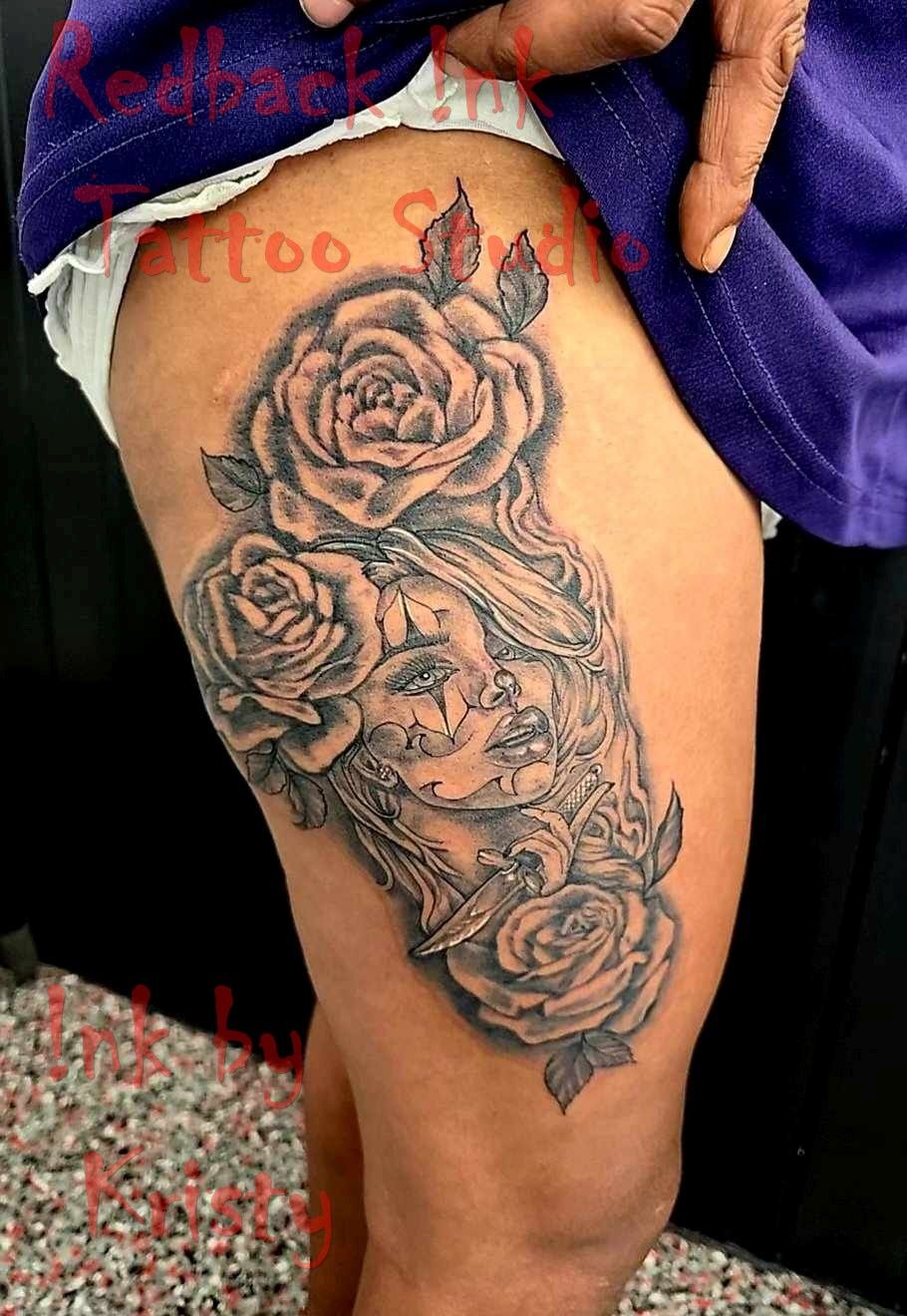 Tattoo on thigh: woman's face with roses, in black and gray — Redback !nk Tattoo Studio in Kawana, QLD