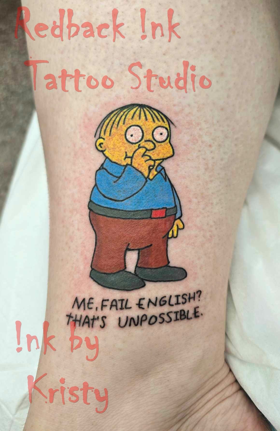 Ralph Wiggum tattoo on ankle with text: 