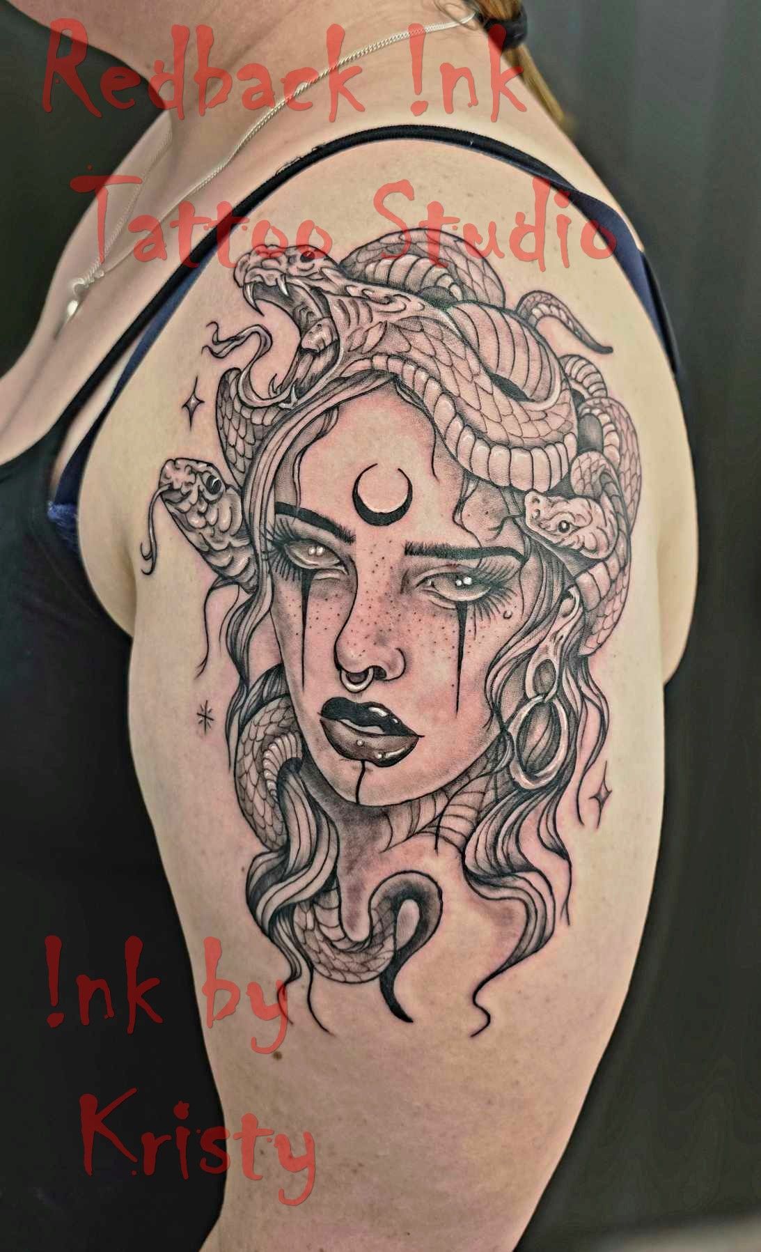 Black and gray Medusa tattoo on shoulder, crescent moon on forehead, snake hair — Redback !nk Tattoo Studio in Kawana, QLD