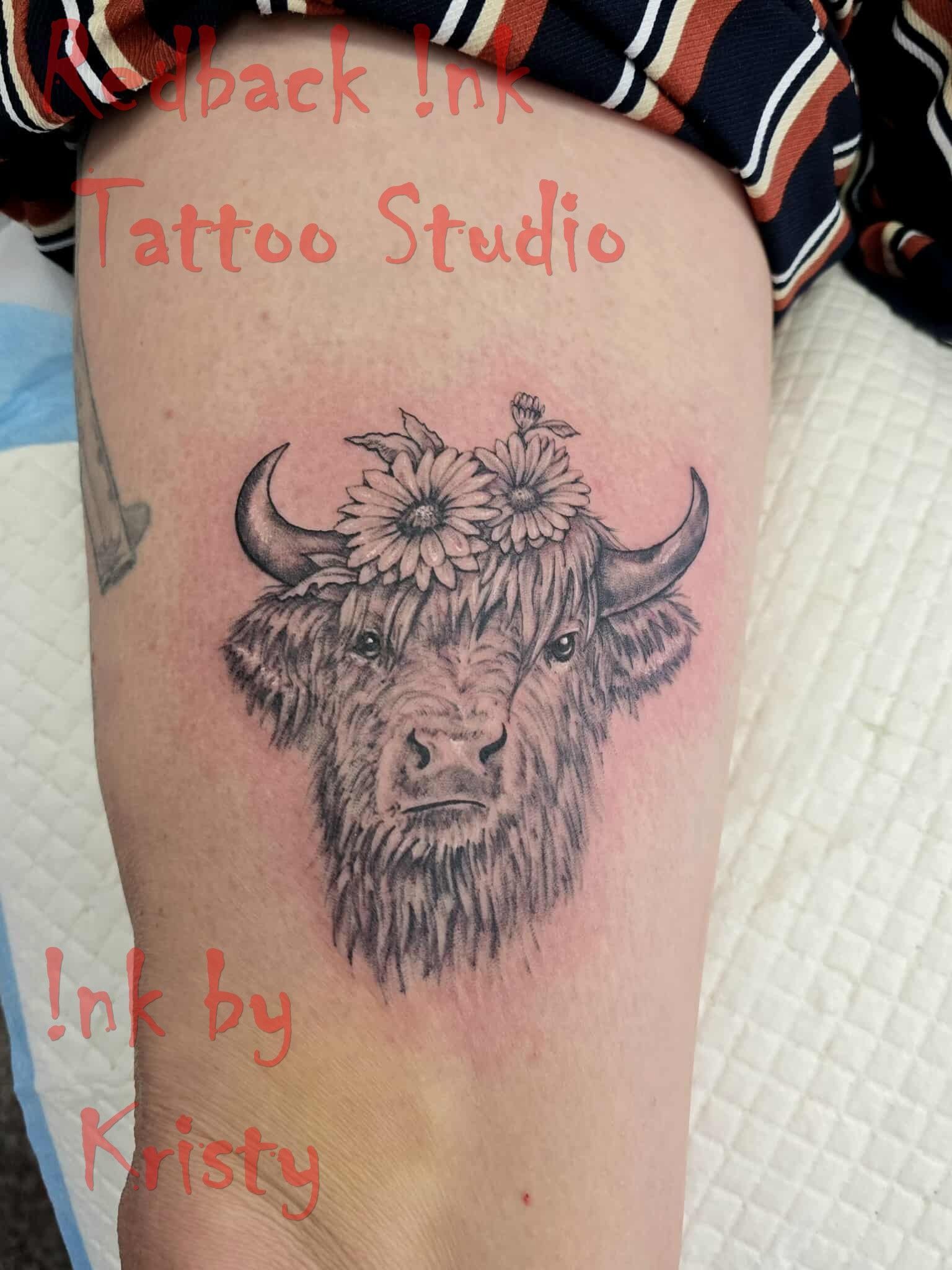 Tattoo of a bison head with a sunflower crown on a person's leg. Black and gray shading — Redback !nk Tattoo Studio in Kawana, QLD