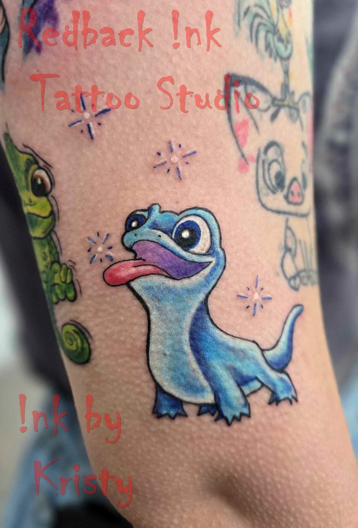 Tattoo of a blue salamander from Frozen II with its tongue out and sparkles. On an arm, with other cartoon characters — Redback !nk Tattoo Studio in Kawana, QLD