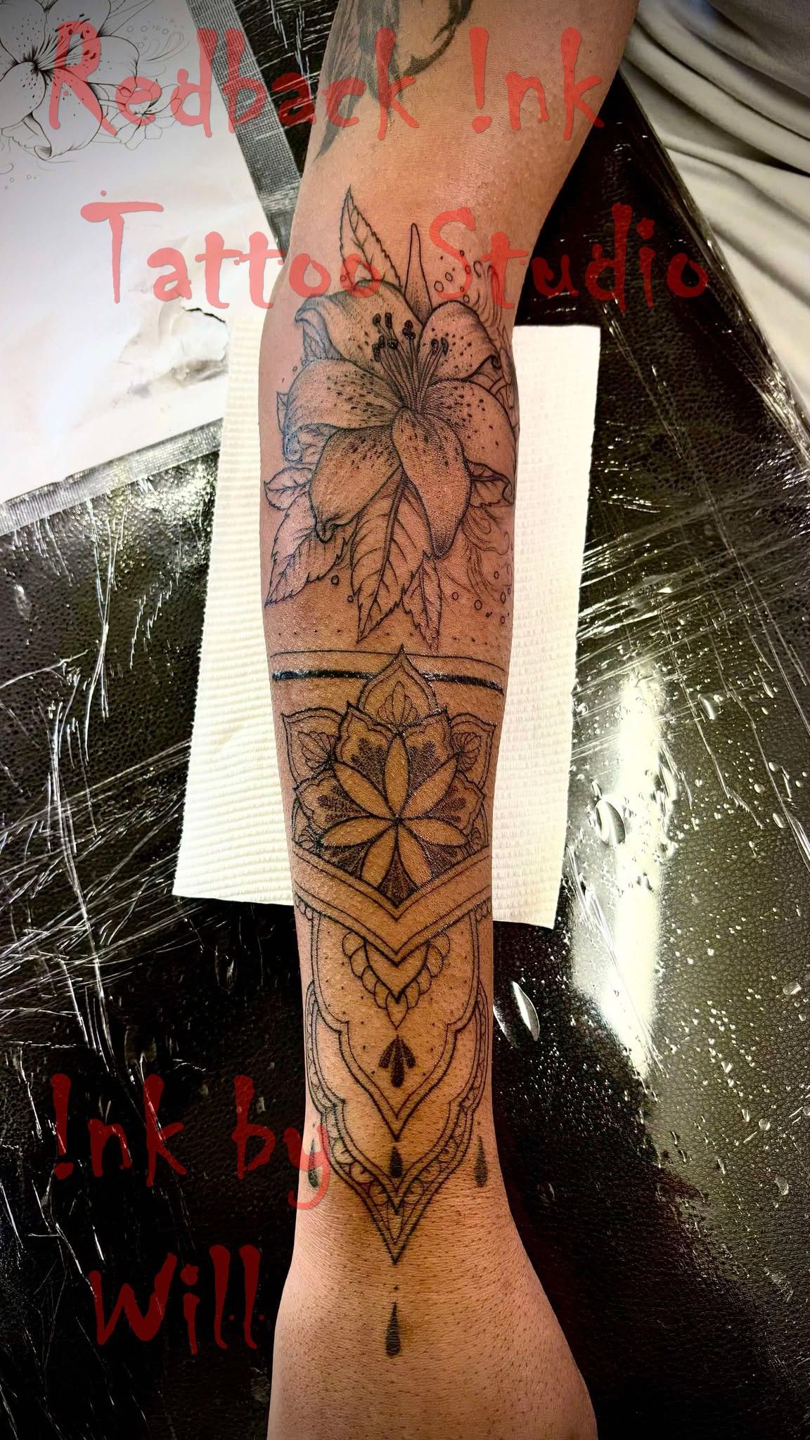Tattoo of a flower and geometric pattern on an arm, inked by Will at Red Ink Tattoo Studio.