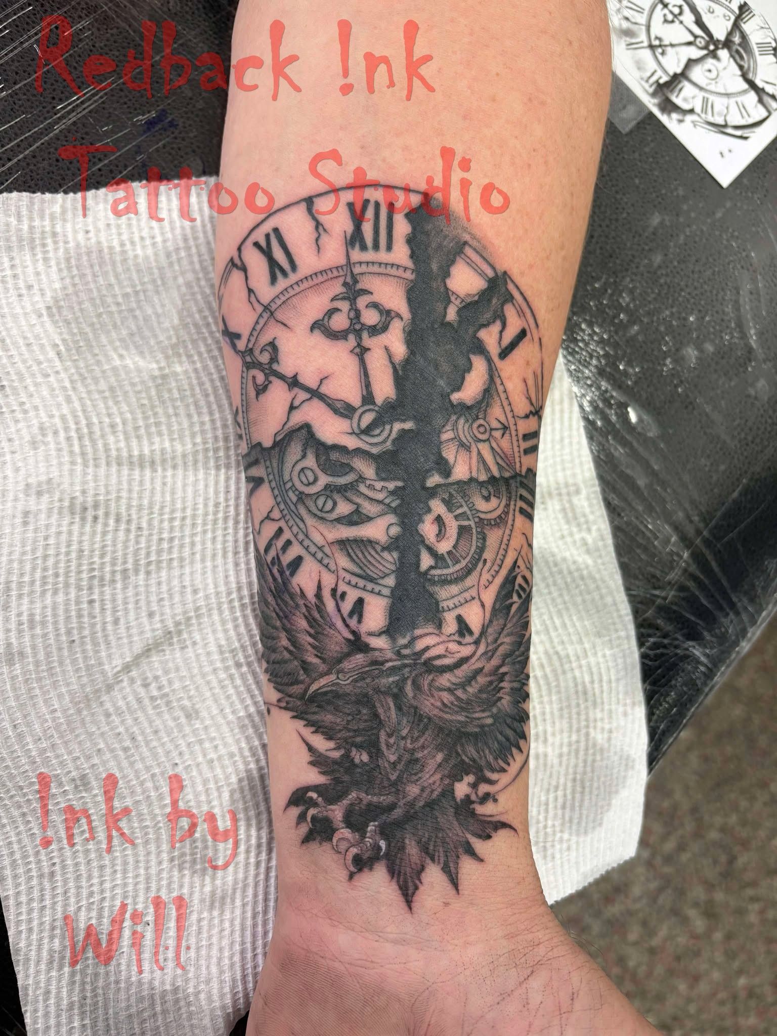 Black and gray owl and clock tattoo on an arm. The tattoo design is split down the center.