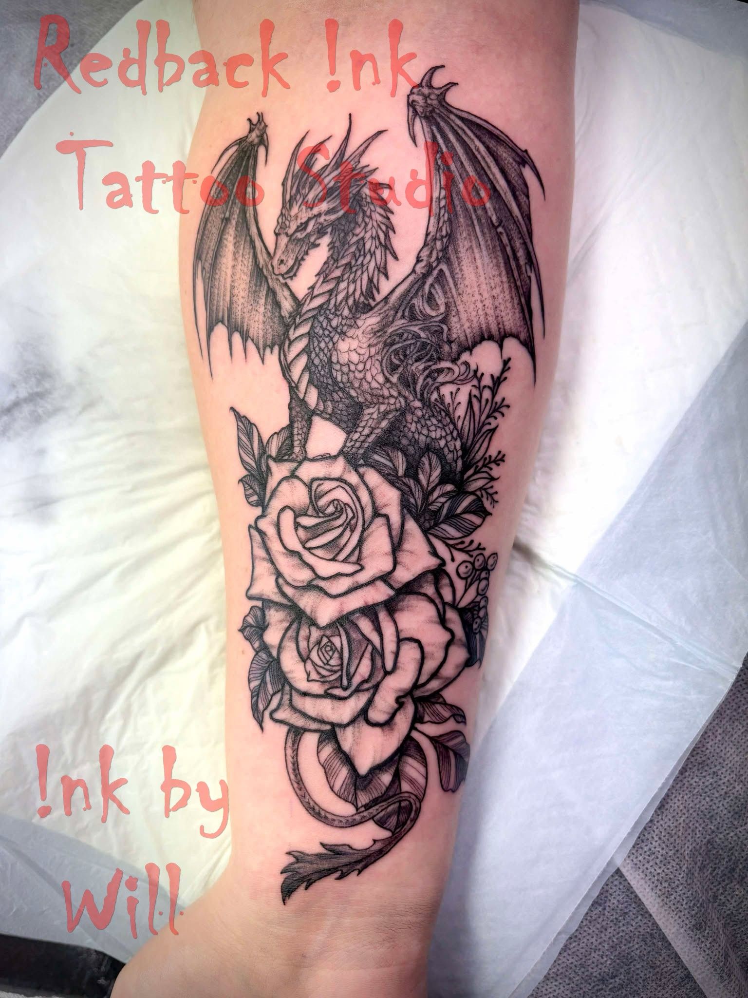 Dragon tattoo with roses on forearm.