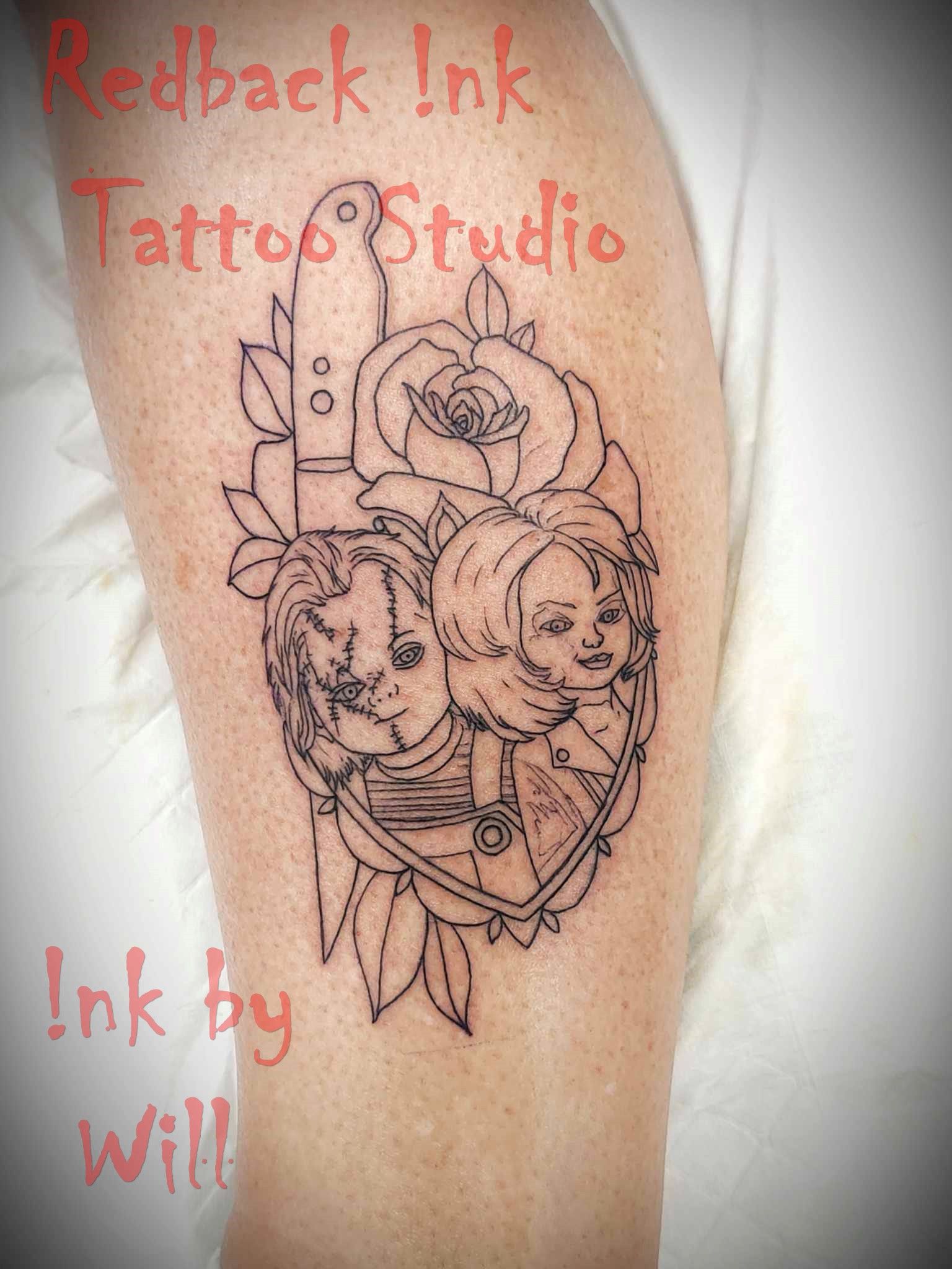 Outline tattoo of a heart with two faces, a rose, and other elements on a leg.