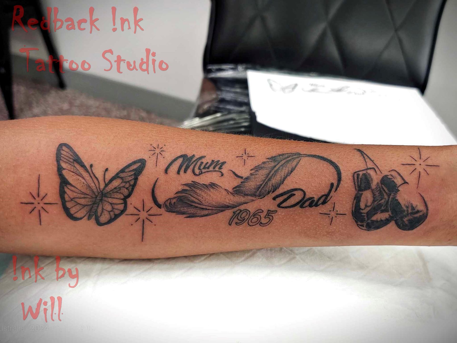 Tattoo on arm, butterfly, feather with 