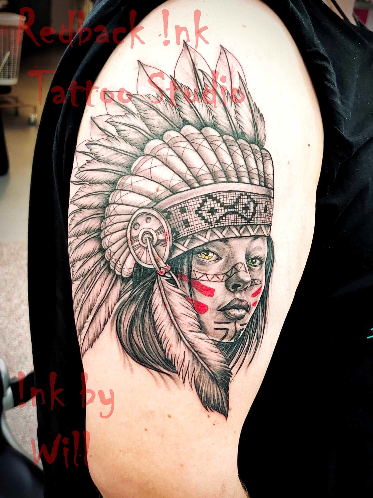 Tattoo of Native American chief on an arm. Black and white design with red accents.