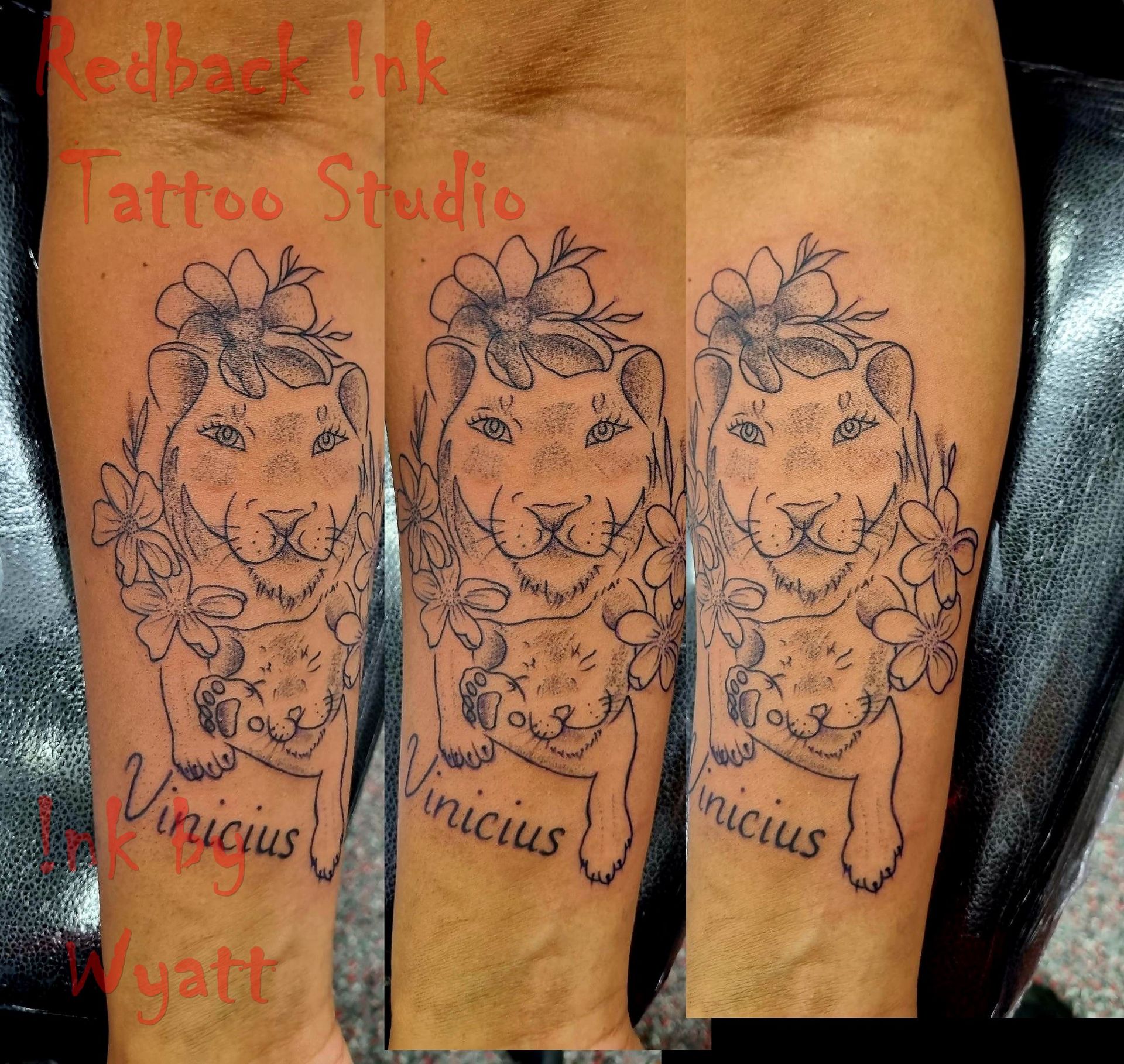 Tattoo of a lioness holding a cub with the name 