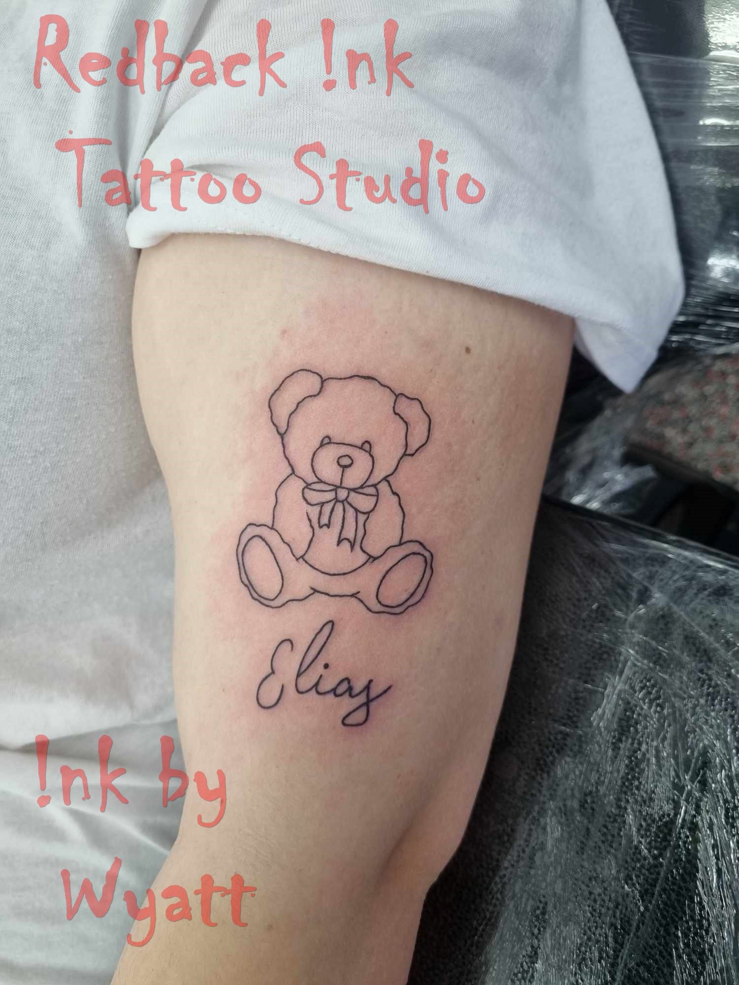Outline tattoo of a teddy bear and the name 