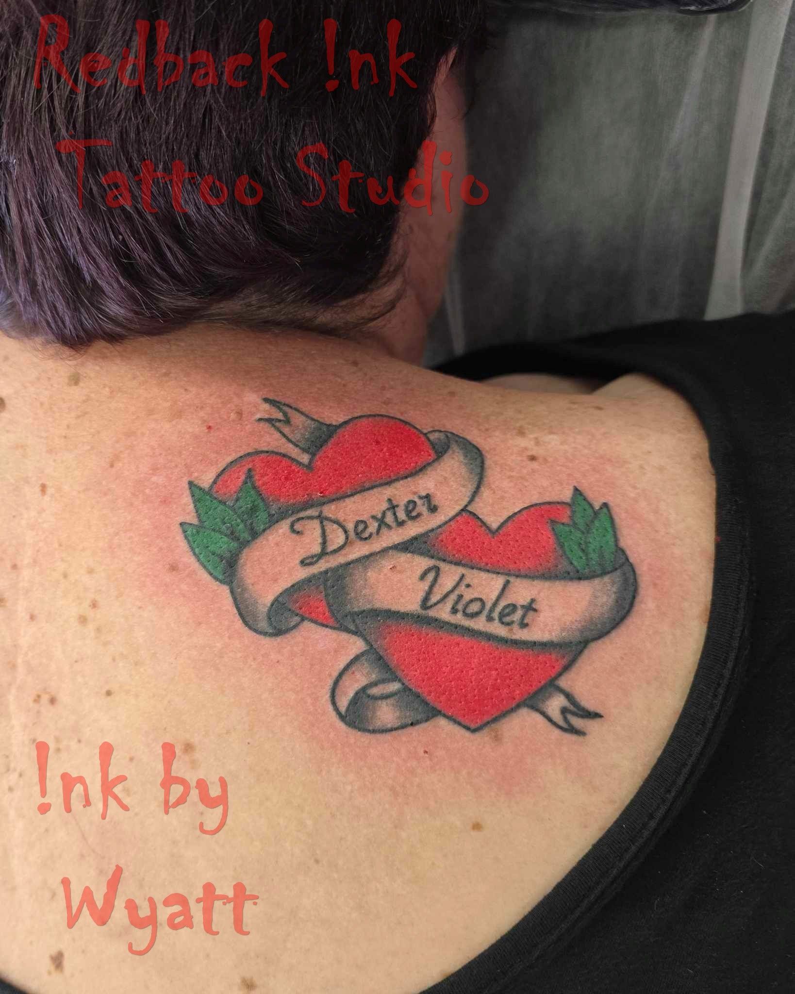 Tattoo of two red hearts with names 